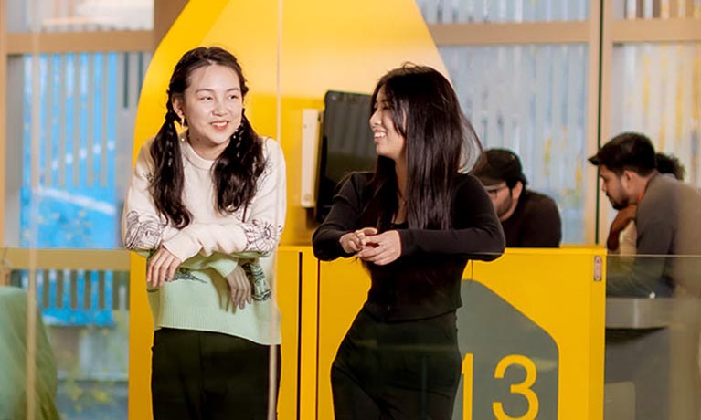 Four international students sitting together talking