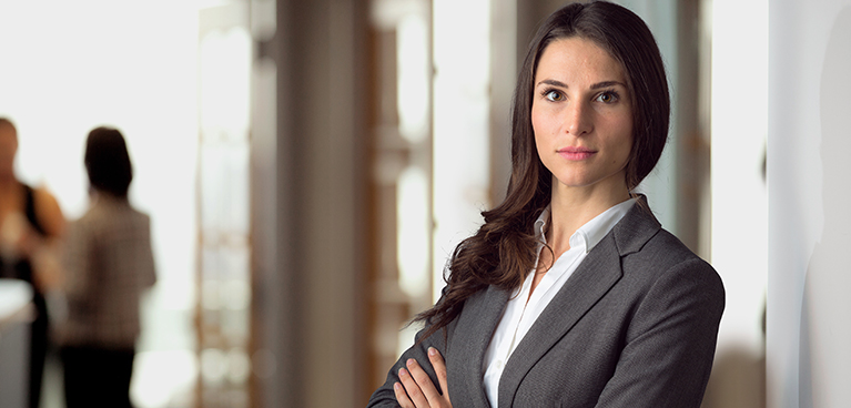 smartly dressed woman looks at screen