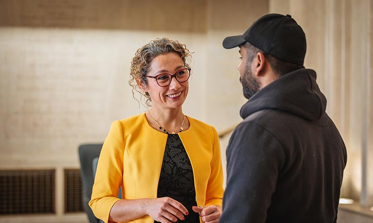 Member of staff talking to a student