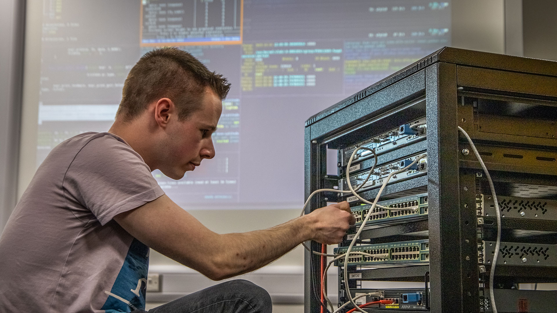 Student working on computer hardware