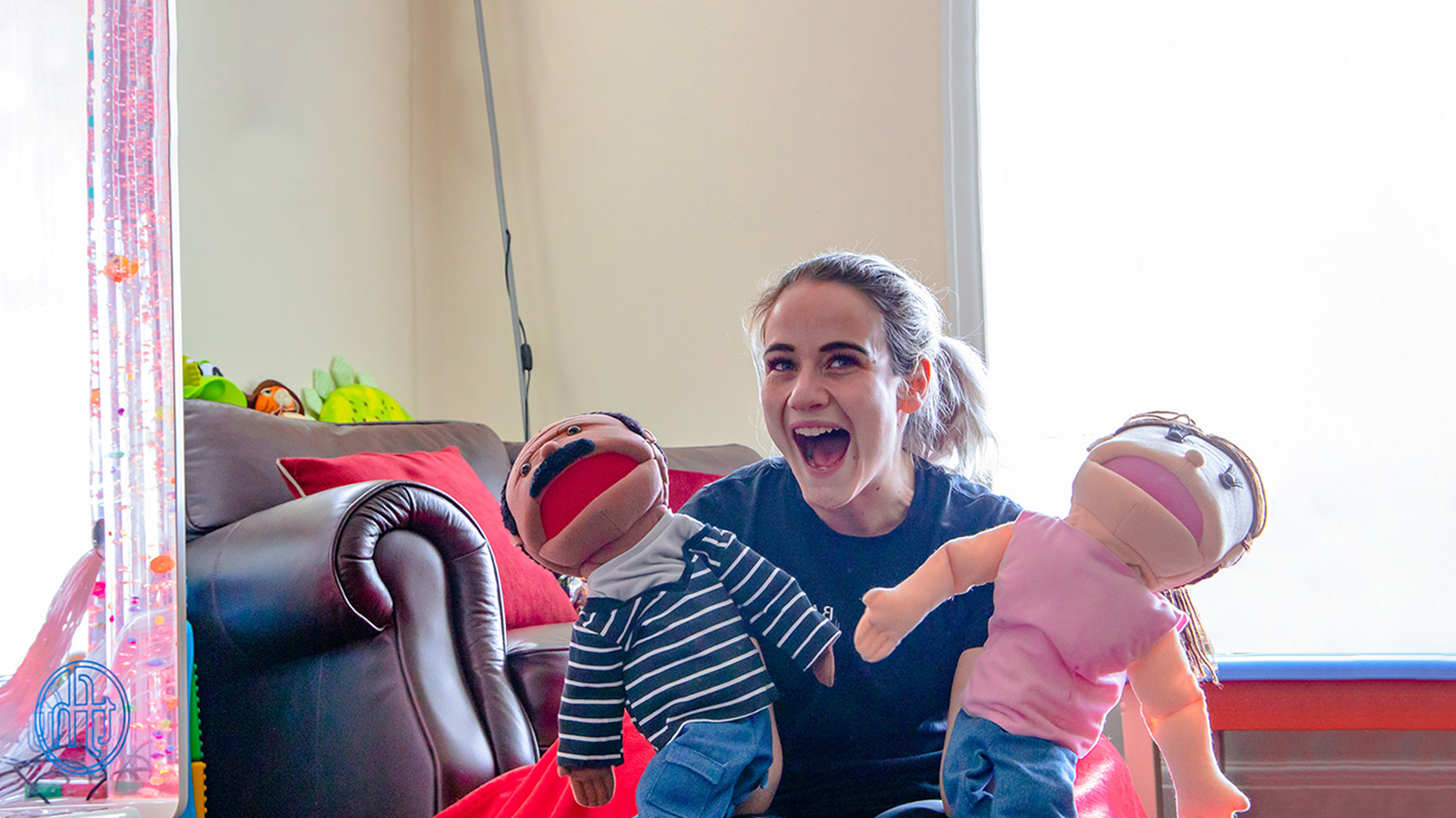 Young female holding two puppets