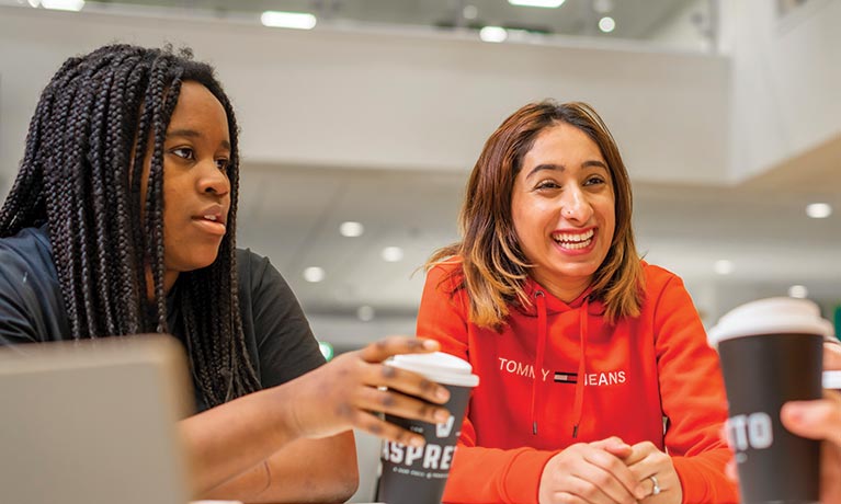 Two females sat a table talking