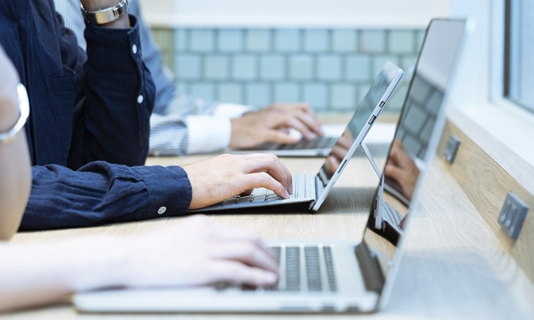 person typing on a laptop
