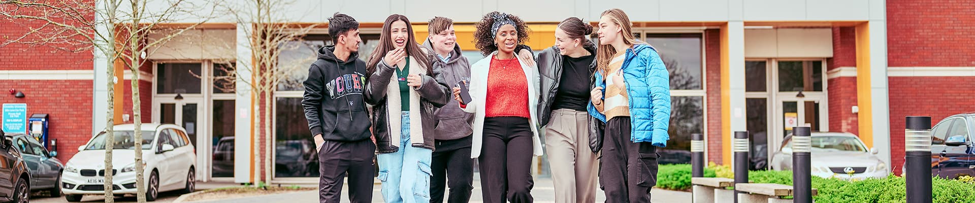 Group of students talking whilst walking away from Mile Lane