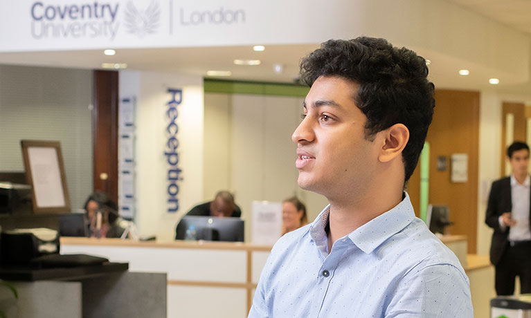 Man standing infront of a reception desk