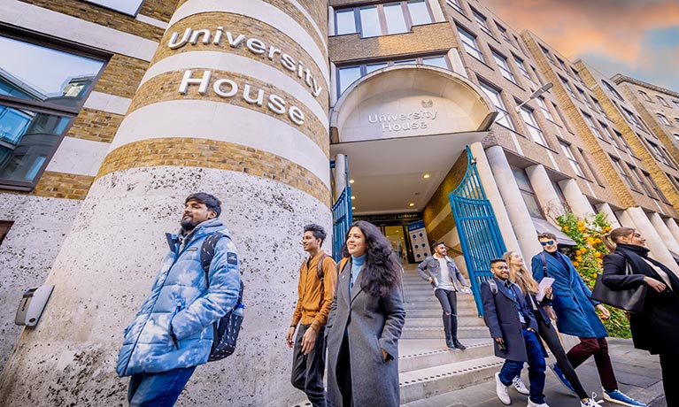 Outside of University house with students walking past