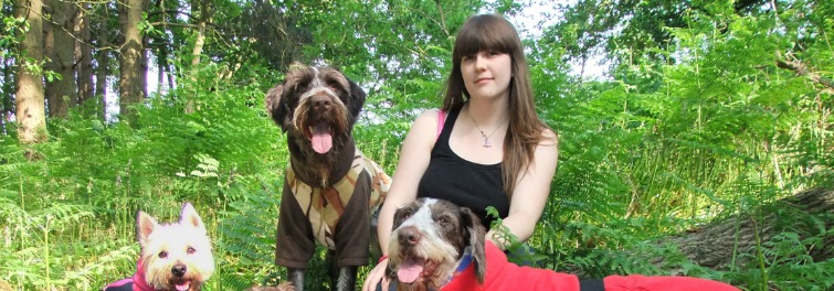 Hayley Bishop with 3 dogs in the woods