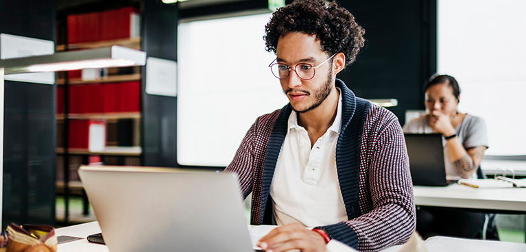 mixed raced man studying online