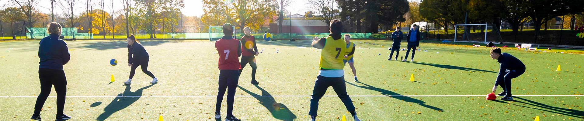 Students playing sports on a sports field